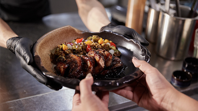 A person holding a plate of food